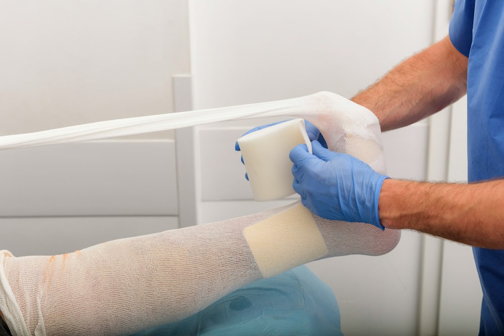 Medical staff bandaging an injured patient's leg