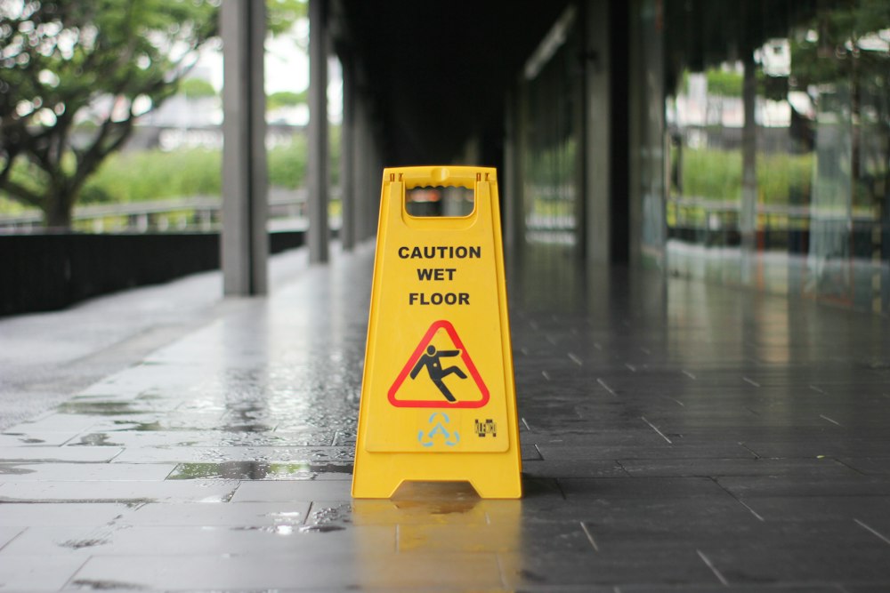 Caution wet floor sign on a slippery walkway