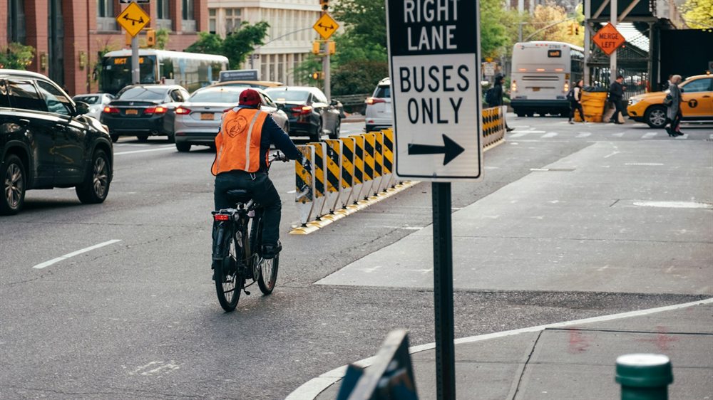 Cyclist riding on a city street beside traffic