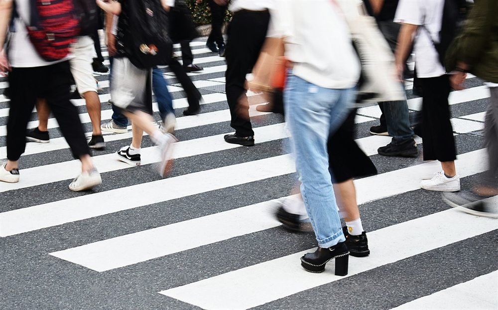People crossing a city crosswalk